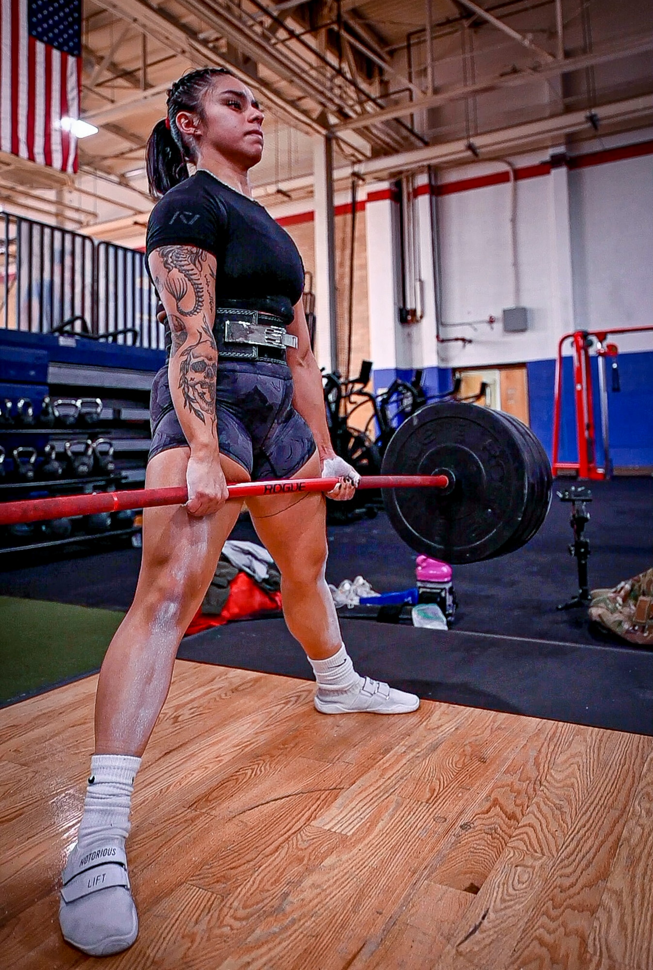 Woman deadlifts.