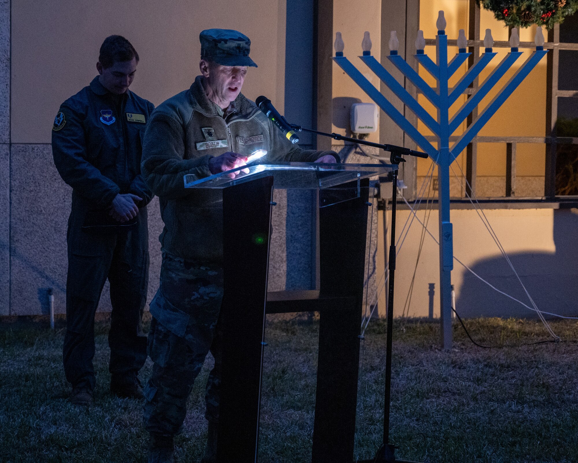 U.S. Air Force Lt Col. Martin Booth, 47th Flying Training Wing wing chaplain, gives a speech at the tree lighting ceremony at Laughlin Air Force Base, Texas, Nov, 29, 2023. The tree lighting ceremony brings families across Laughlin together to join in the festive spirit. (U.S. Air Force photo by Staff Sgt. Nicholas Larsen)