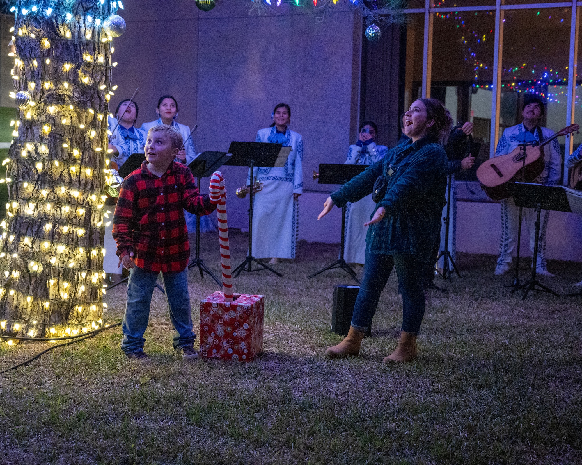 Hunter and Melanie Botto, family of Tech Sgt. Joshua Botto, 47th Security Forces Squadron NCOIC of logistics, pulls the lever to light the tree at Laughlin Air Force Base, Texas, Nov. 29, 2023. The tree lighting ceremony brings Airmen together at the chapel to celebrate holiday festivities. (U.S. Air Force photo by Staff Sgt. Nicholas Larsen)