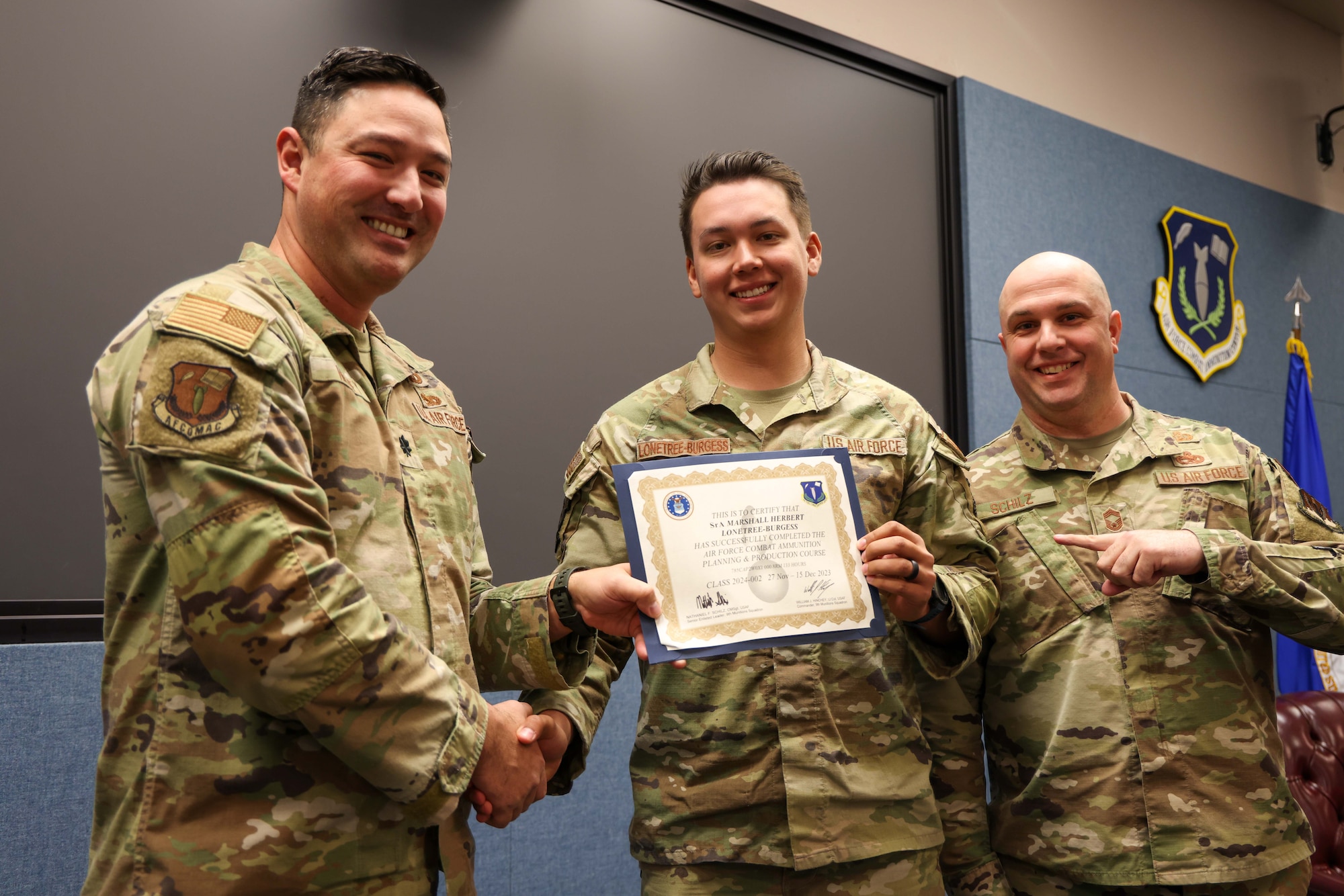 U.S. Air Force Senior Airman Marshall Lonetree-Burgess, 649th Munitions Squadron munition inspector from Hill Air Force Base, Utah, receives his certificate of completion for the Air Force Combat Ammunition Course (AFCOMAC), Dec. 15, 2023, on Beale Air Force Base, California.