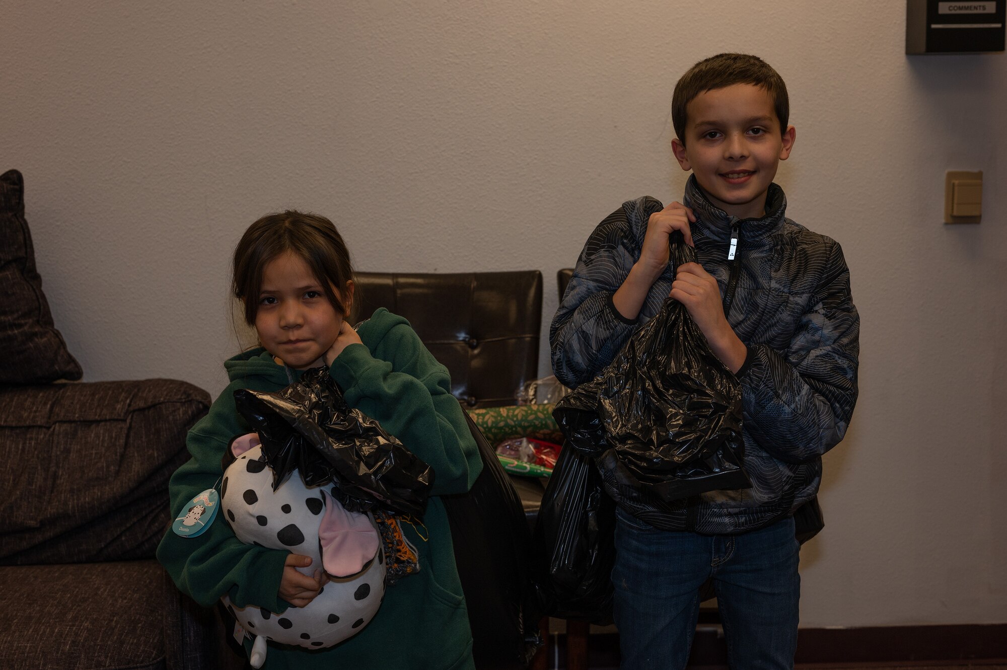 Children who participated in the "Shop with a Cop" event pack up all their gifts on Eielson Air Force Base, Alaska, Dec. 17, 2023. This event is hosted across police departments throughout surrounding cities and aims to create positive community relations between police officers and the younger generation. (U.S. Air Force photo by Airman Spencer Hanson)