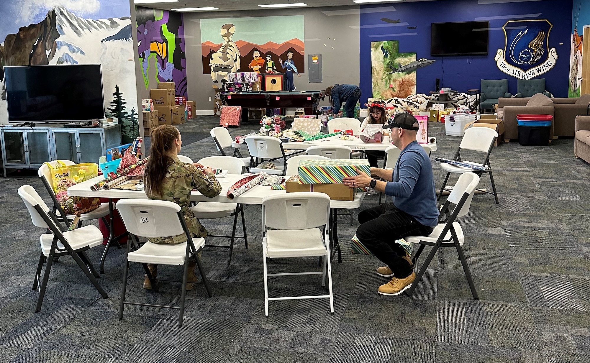 Volunteers wrap gifts to be distributed