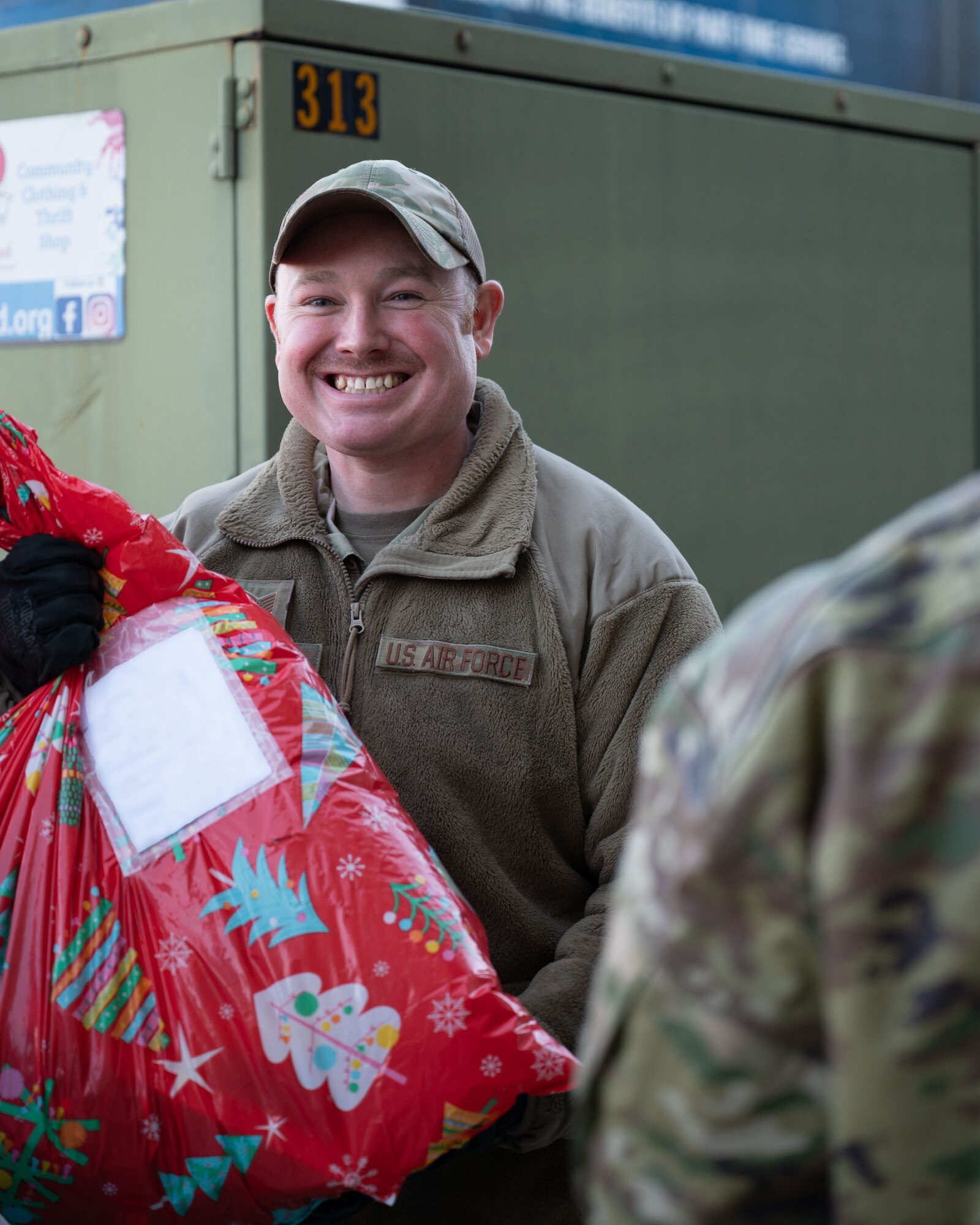 Airman carries gifts inside