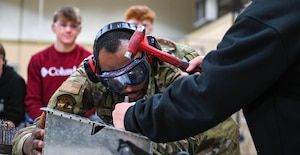 Students and faculty from Douglas High School pose with members from the 28th Maintenance Squadron Fabrication Flight at Ellsworth Air Force Base, South Dakota, Dec. 12, 2023.