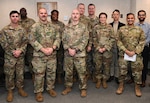 U.S. Space Force Lt. Col. Joshua McCullion, U.S. Space Forces Korea commander, center left, and Master Sgt. Shawn Stafford, USSPACEFOR-KOR senior enlisted leader, and other members of SPACEFOR-KOR, pose for a photo with the Space Systems Command Galaxy X cohort during their visit to Osan Air Base, Republic of Korea, November 30, 2023. The Galaxy X cohort is currently completing the travel portion of the six-month Galaxy Program, a joint rapid professional development program that provides a rapid capability delivery experience for SSC and National Reconnaissance Office Guardians and civilians. SPACEFOR-KOR hosted the cohort for four days of professional development engagements focused on joint collaboration and cultural exchange, Nov. 28 – Dec. 1. (U.S. Air Force photo by Master Sgt. Eric Burks)
