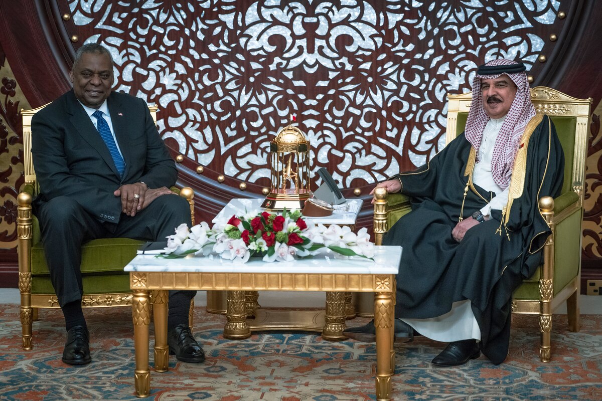 Two men are seated next to each other.