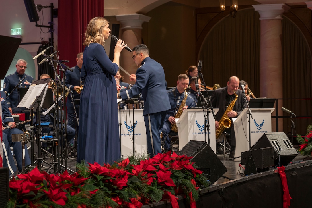 U.S. Air Force Tech. Sgt. Michelle Doolittle, U.S. Air Forces in Europe - Air Forces Africa band vocalist, sings at the Kaiserslautern Military Community Christmas Concert in Kaiserslautern, Germany, Dec. 16, 2023. The annual concert has been a tradition for 40 years, and serves as a thank you to the community for their acceptance, hospitality and support of U.S. forces and their families. (U.S. Air Force photo by Senior Airman Madelyn Keech)