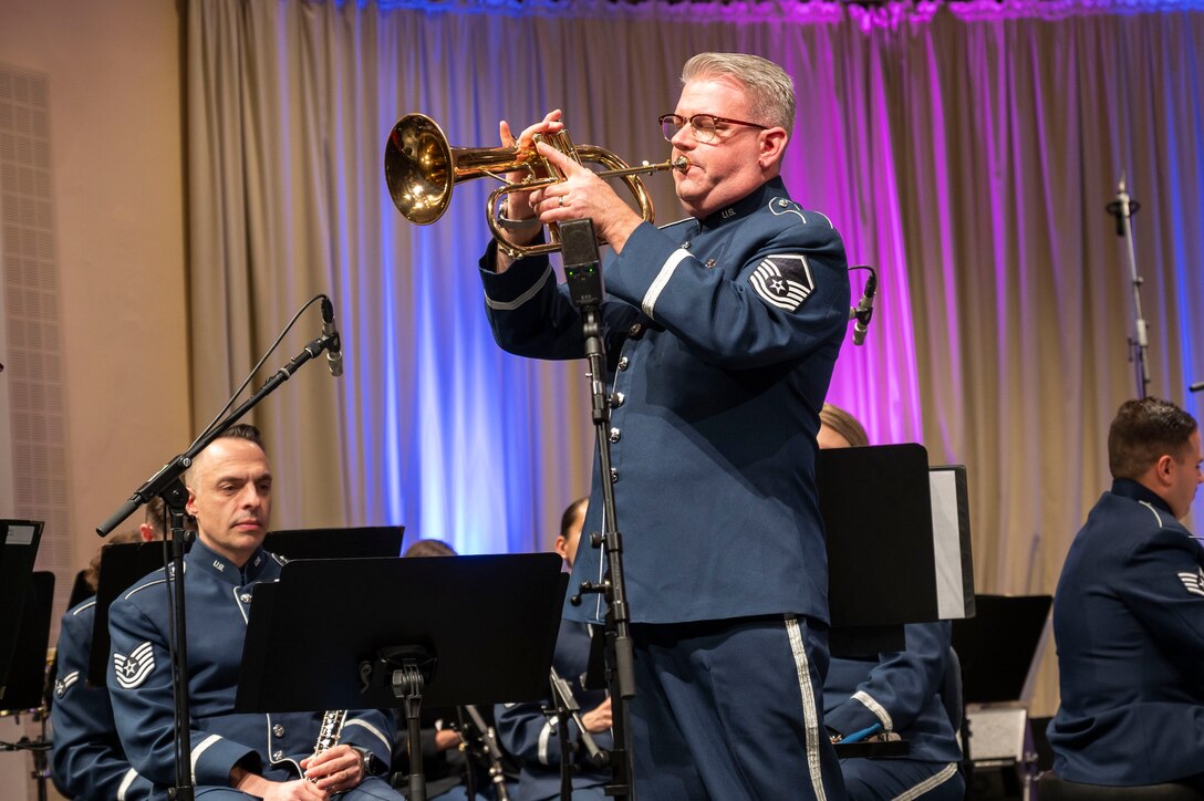 Retired U.S. Air Force Master Sgt. Dave Dell, trumpeter, performs a solo at the Kaiserslautern Military Community Christmas Concert in Kaiserslautern, Germany, Dec. 16, 2023. The annual concert has been a tradition for 40 years, and serves as a thank you to the community for their acceptance, hospitality and support of U.S. forces and their families. (U.S. Air Force photo by Senior Airman Madelyn Keech)