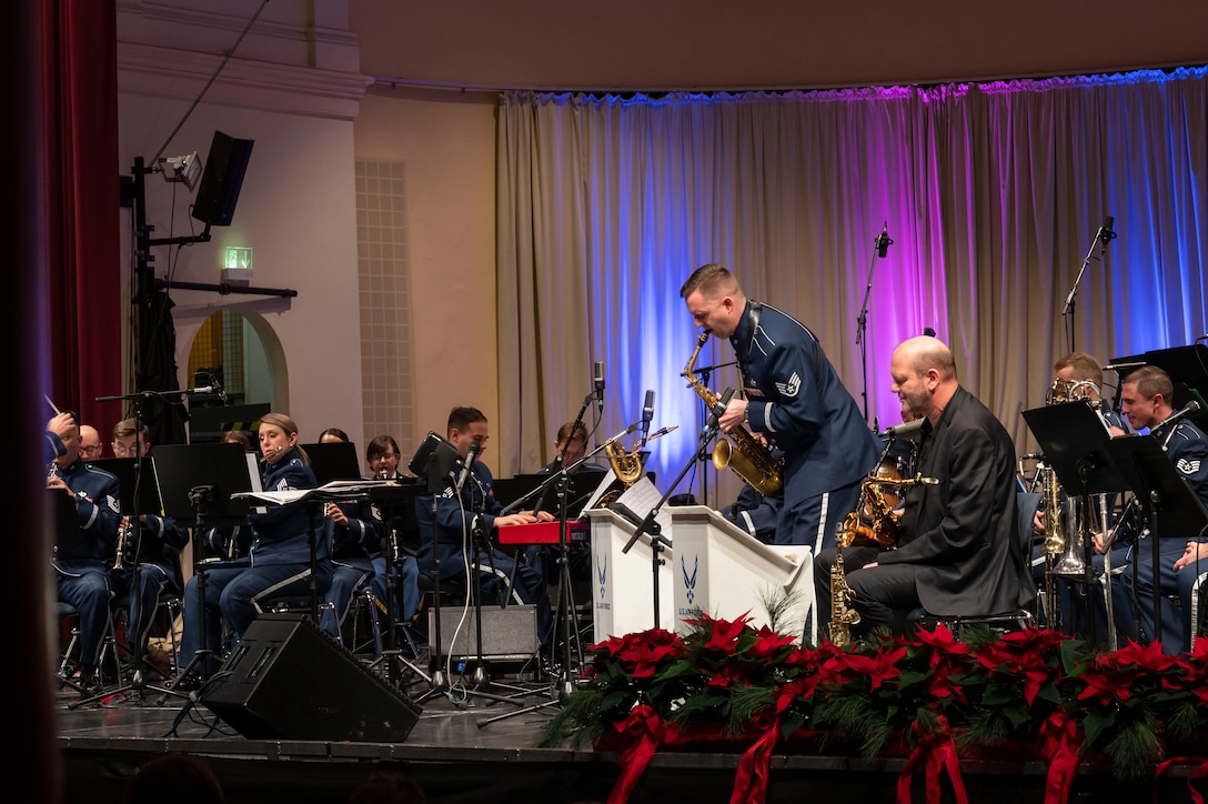 U.S. Air Force Staff Sgt. Joe Rulli, U.S. Air Forces Europe - Air Forces Africa band saxophonist, performs a solo during the Kaiserslautern Military Community Christmas Concert in Kaiserslautern, Germany, Dec. 16, 2023. The annual holiday concert has been a tradition for 40 years, and serves as a thank you to the community for their acceptance, hospitality and support of U.S. forces and their families.  (U.S. Air Force photo by Senior Airman Madelyn Keech)