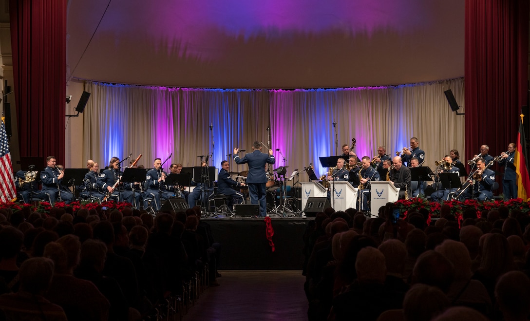 U.S. Air Force Airmen assigned to the U.S. Air Forces in Europe - Air Forces Africa band perform at the Kaiserslautern Military Community Christmas Concert in Kaiserslautern, Germany, Dec. 16, 2023. The annual holiday concert has been a tradition for 40 years, and serves as a thank you to the community for their acceptance, hospitality and support of U.S. forces and their families  (U.S. Air Force photo by Senior Airman Madelyn Keech)