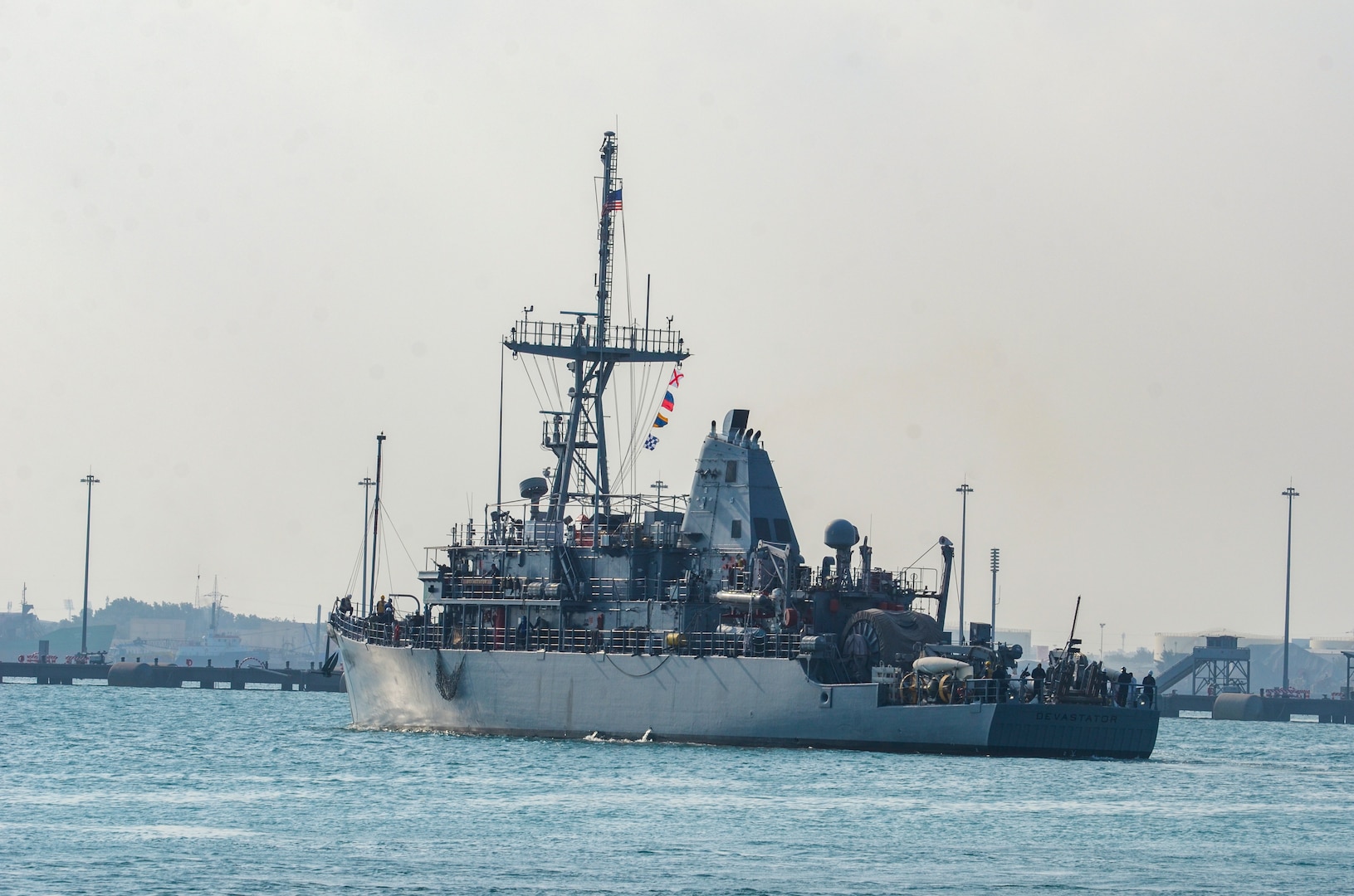 MANAMA, Bahrain (Dec. 17, 2023) U.S. Navy Avenger-class mine countermeasures ship USS Devastator (MCM 6) departs Naval Support Activity (NSA) Bahrain for sea trials, Dec. 17. NSA Bahrain enables the forward operations and responsiveness of U.S. and allied forces in support of Navy Region Europe, Africa, Southwest Asia's mission to provide services to the fleet, warfighter and family. (U.S. Navy photo by Mass Communication Specialist 2nd Class MacAdam Kane Weissman)