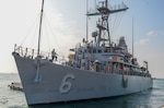 MANAMA, Bahrain (Dec. 17, 2023) U.S. Navy Avenger-class mine countermeasures ship USS Devastator (MCM 6) departs Naval Support Activity (NSA) Bahrain for sea trials, Dec. 17. NSA Bahrain enables the forward operations and responsiveness of U.S. and allied forces in support of Navy Region Europe, Africa, Southwest Asia's mission to provide services to the fleet, warfighter and family. (U.S. Navy photo by Mass Communication Specialist 2nd Class MacAdam Kane Weissman)