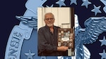 Man holds plaque with coins attached