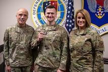A photo of three Airmen posing for the camera.
