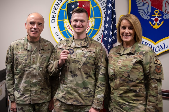 A photo of three Airmen posing for the camera.