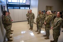 A photo of many Airmen talking.