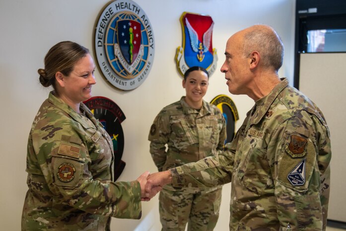 A photo of an Airman receiving a coin.