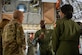 A photo of an Airman briefing leadership on a C-17.