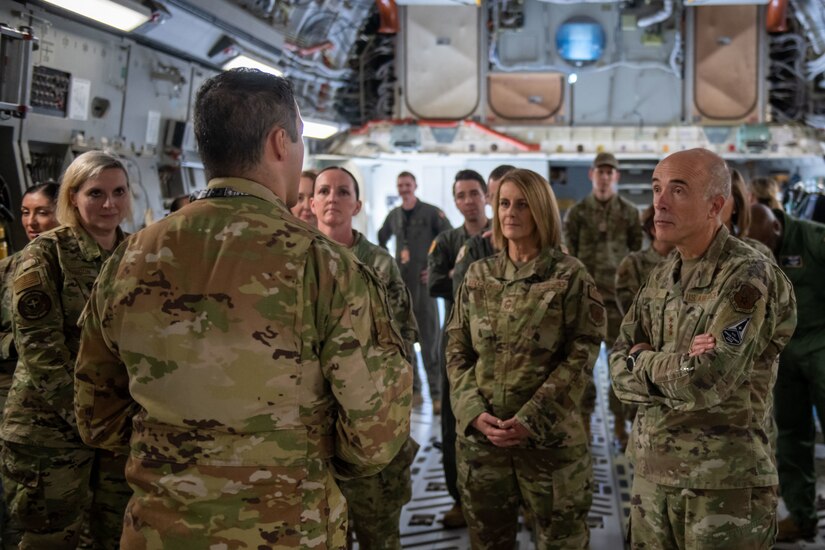 A photo of an Airman briefing leadership on a C-17.