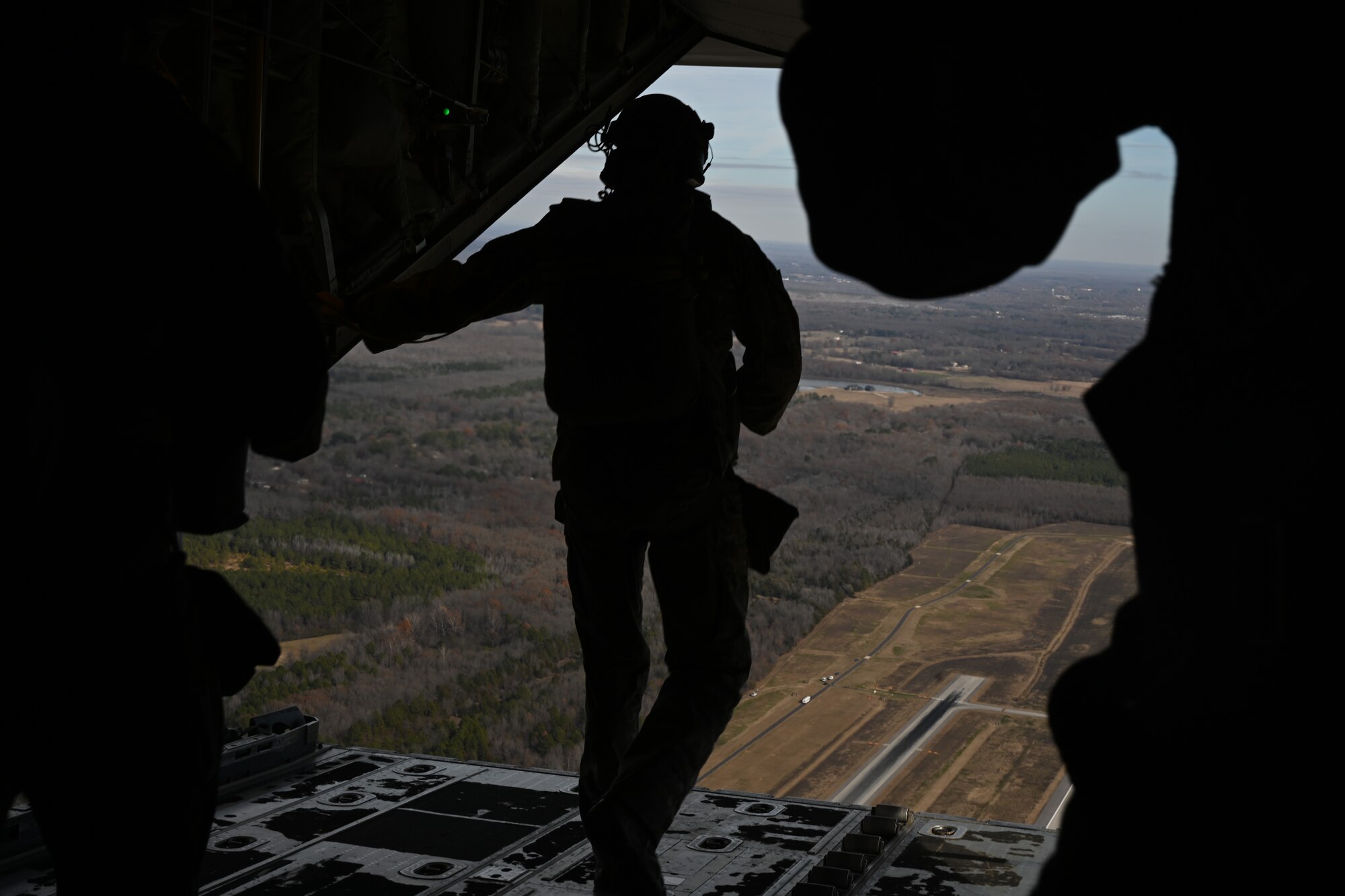 A SERE specialist prepares to jump from a C-130J Super Hercules