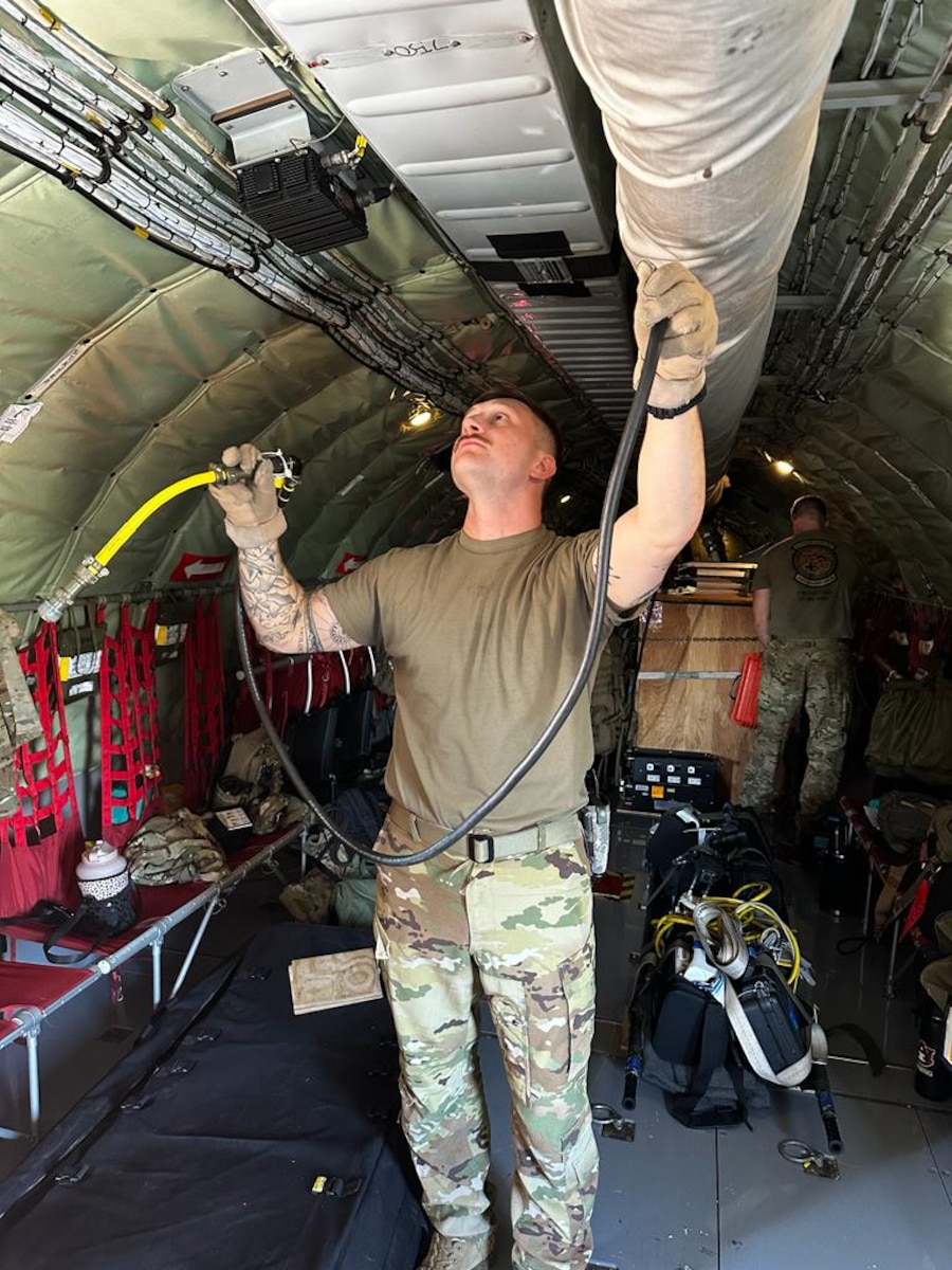 people prep an aircraft for training