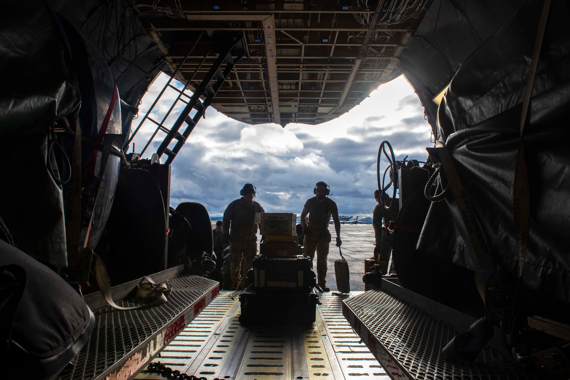 U.S. Air Force Airmen and Navy Sailors load mini submersibles and cargo inside a C-5M Super Galaxy at Joint Base Lewis-McChord, Wash., Dec. 8, 2023. The joint operation consisted of loading cargo and mini submersibles on the aircraft and was conducted by service members from Travis Air Force Base, Calif., Joint Base Pearl Harbor-Hickam, Hawaii, and JBLM. (U.S. Air Force photo by Airman 1st Class Megan Geiger)