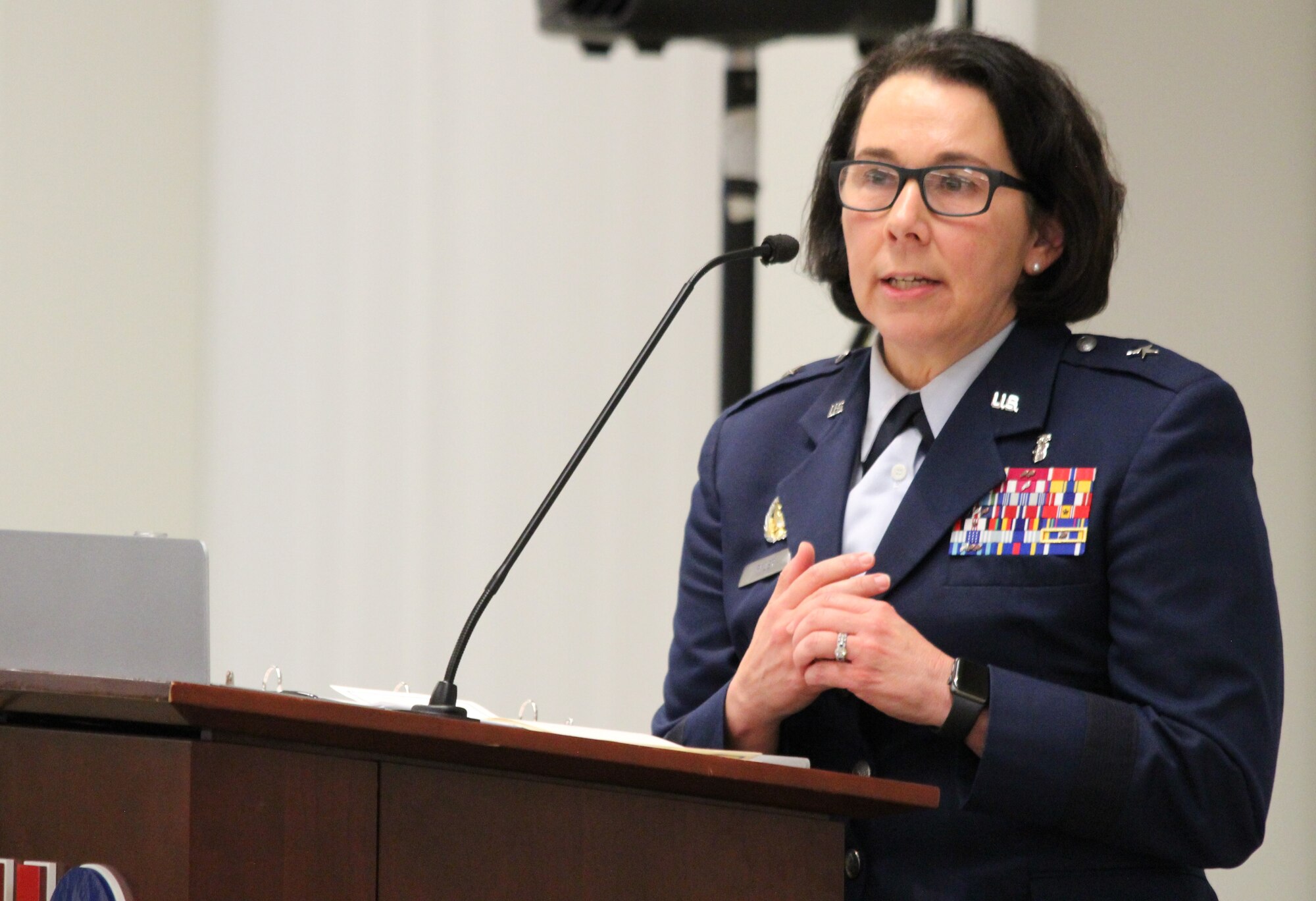 Image of an Airmen speaking at a podium