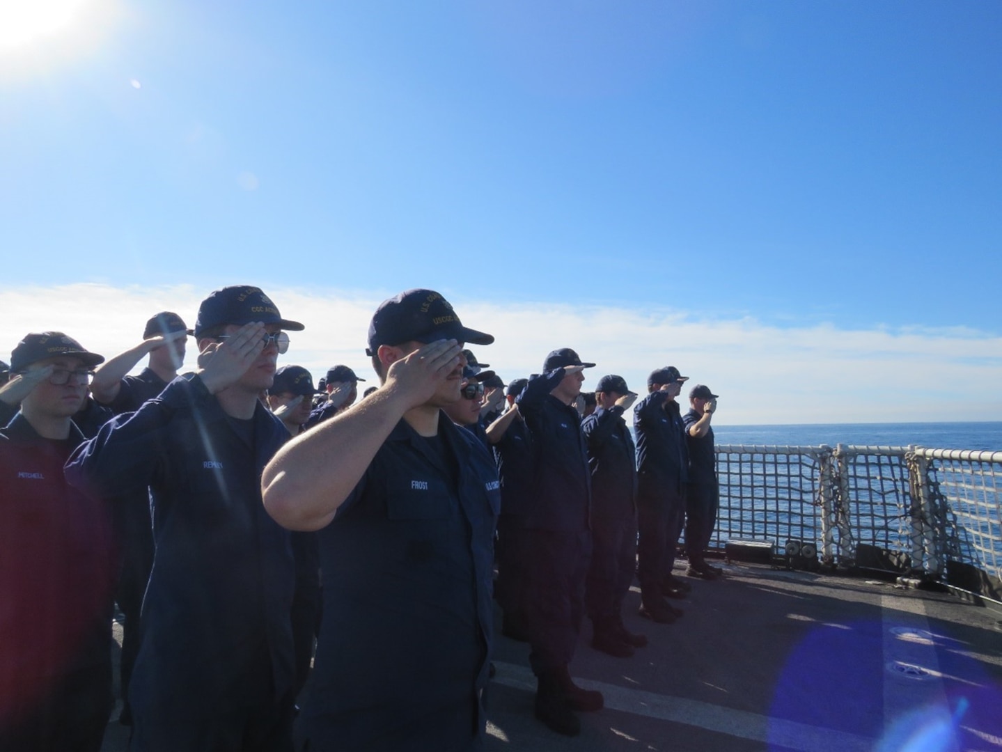 The U.S. Coast Guard Cutter Active personnel renders a salute to AME2 Legg, U.S. Navy, during his burial at sea in the Eastern Pacific Ocean, Oct. 30, 2023. (U.S. Coast Guard photo by Ensign Thomas Gehman)