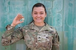 U.S. Army Sgt. Liliana Munday, 218th Maneuver Enhancement Brigade, South Carolina National Guard, holds her French Desert Commando pin Dec. 19, 2023, at Camp Lemonnier, Djibouti. Munday was one of 40 U.S. service members and the only female to go through the most recent iteration of the French Desert Commando Course.