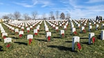 Volunteers placed wreaths in front of headstones at the National Cemetery of the Alleghenies as part of Wreathes Across America, Bridgeville, Pennsylvania, Dec. 16, 2023.