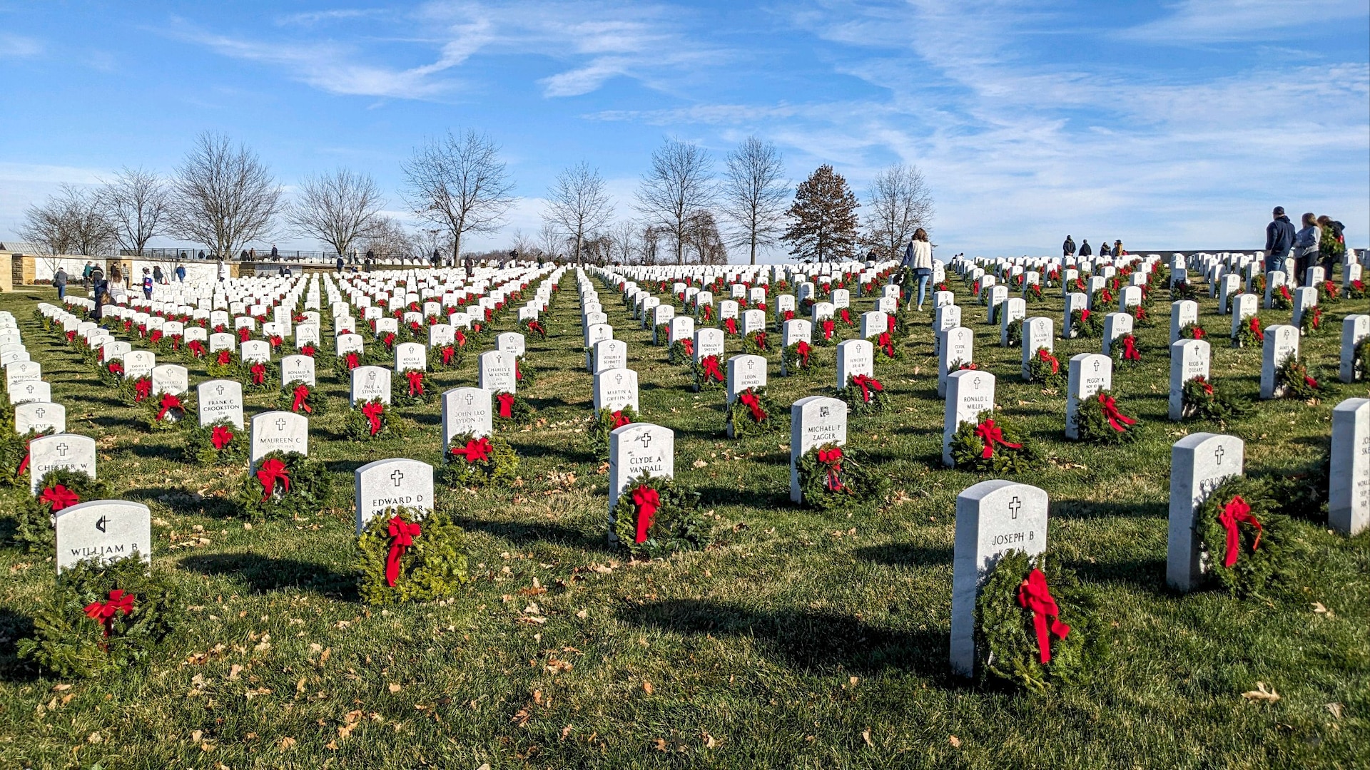 Volunteers placed wreaths in front of headstones at the National Cemetery of the Alleghenies as part of Wreathes Across America, Bridgeville, Pennsylvania, Dec. 16, 2023.