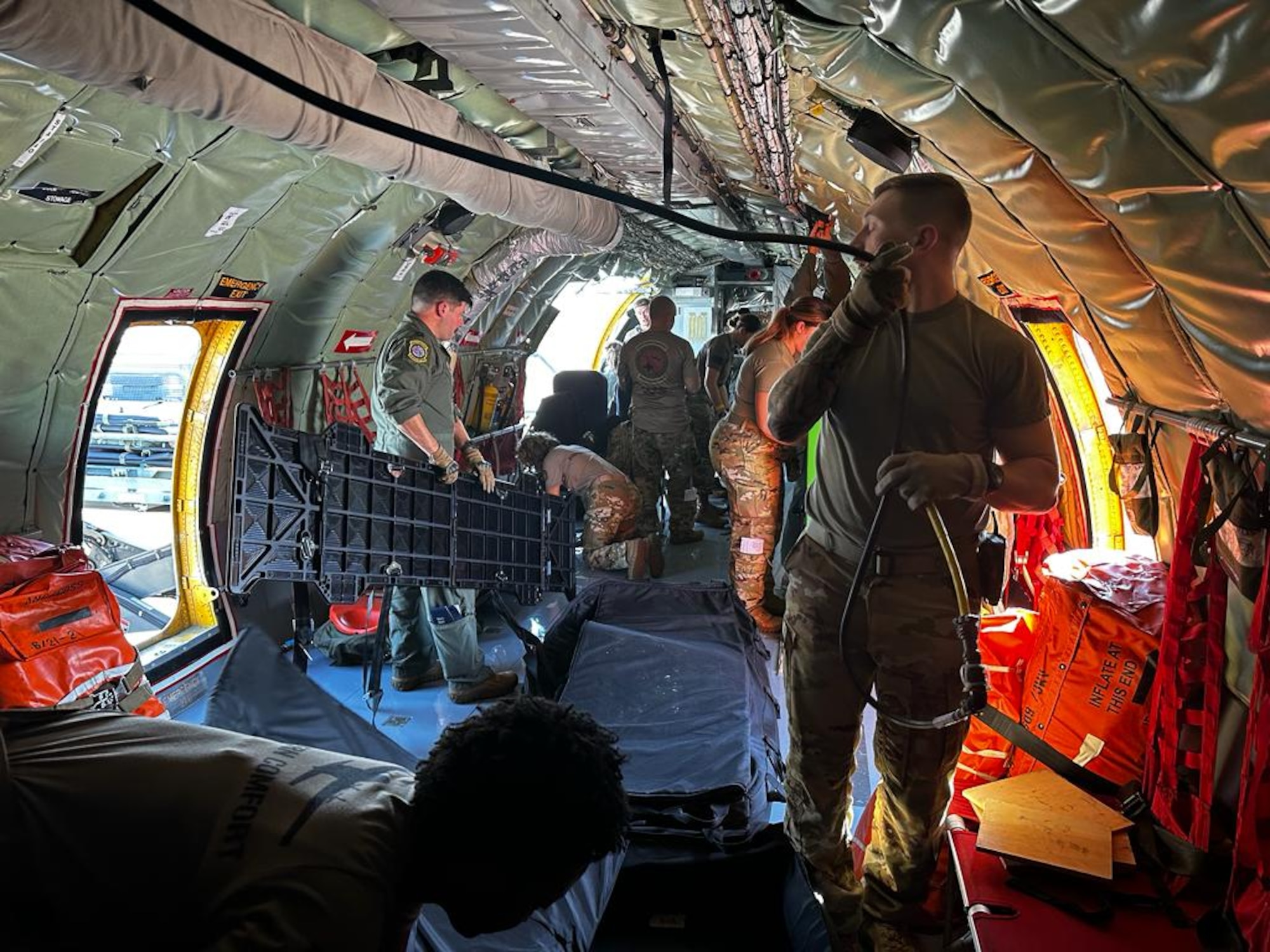 people prep an aircraft for training