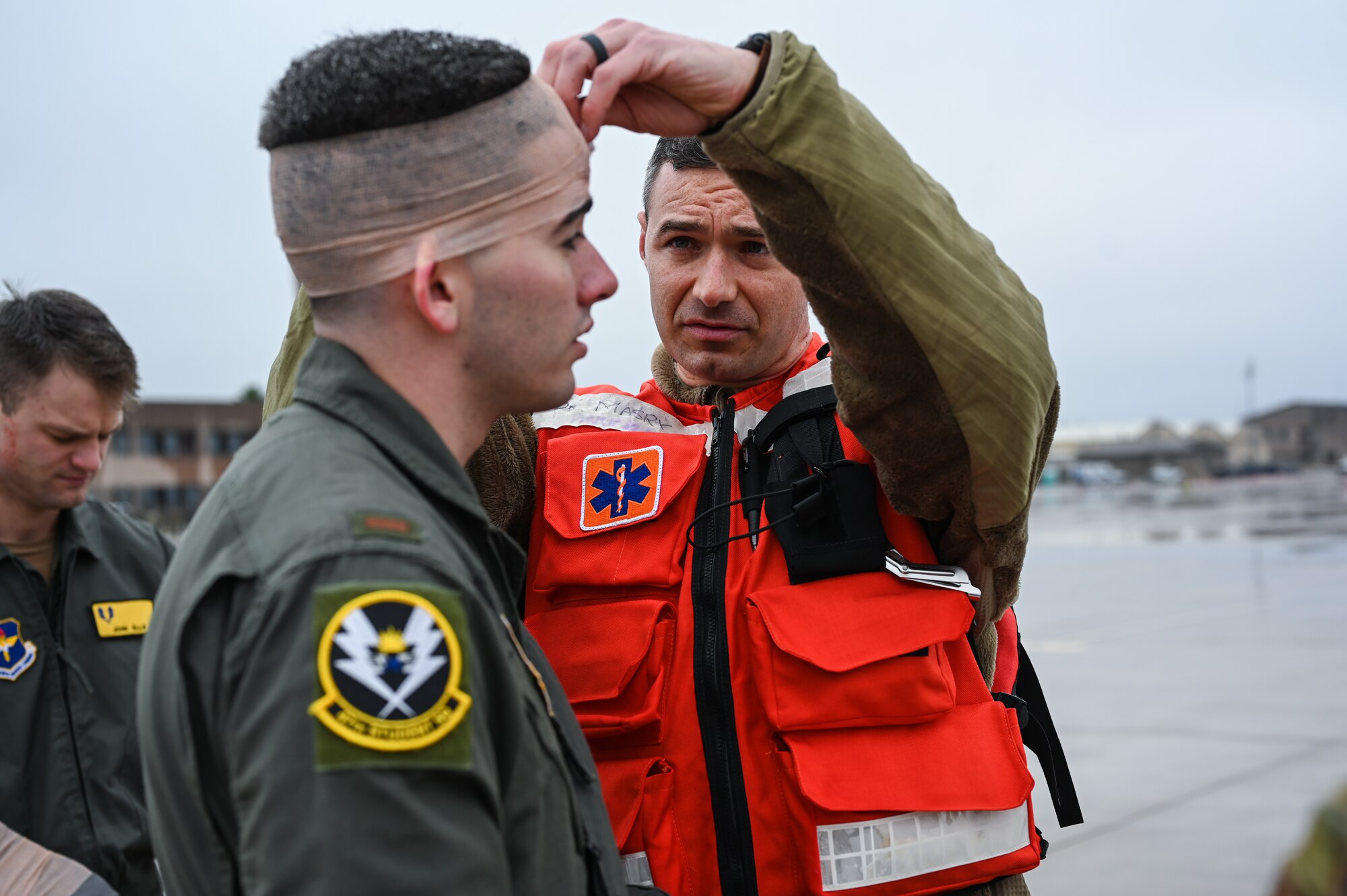 U.S. Air Force Capt. Colin Sulpizio (left), 47th Medical Group family physician, checks the simulated head wound of 2nd Lt. Antonio Izquierdo, 47th Student Squadron student pilot, during a Major Accident Response Exercise (MARE) on the flight line at Laughlin Air Force Base, Texas, Dec. 14, 2023
