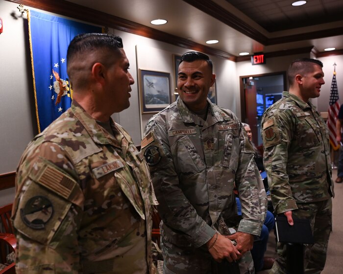 U.S. Air Force Chief Master Sgt. Christopher Campbell, 316th Training Squadron senior enlisted leader, talks with Chief Master Sgt. Robert Laning, 312th TRS senior enlisted leader before the 17th Training Wing brief at the Norma Brown headquarters building, Goodfellow, Air Force Base, Texas, Dec. 7, 2023. Campbell enlisted in the Air Force in 2006. (U.S. Air Force photo by Airman 1st Class Evelyn D'Errico)