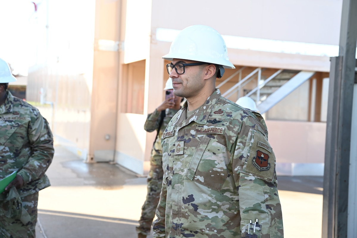 U.S. Air Force Chief Master Sgt. Christopher Campbell, 316th Training Squadron senior enlisted leader, listens to a safety briefing on the fire pad at the Louis F. Garland Department of Defense Fire Academy, Goodfellow Air Force Base, Texas, Dec. 7, 2023. The 316th TRS’s mission is to develop leaders and deliver relevant and realistic joint intelligence, surveillance, and reconnaissance training for the Department of Defense. (U.S. Air Force photo by Airman 1st Class Evelyn D'Errico)