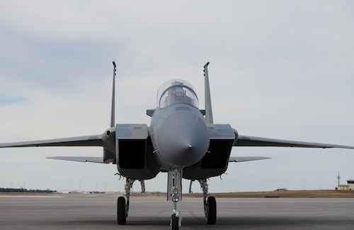 A F-15X Eagle aircraft's front nose taxies forward on the runway.