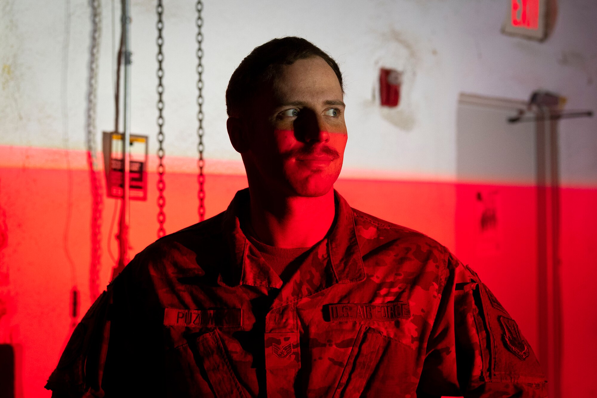 U.S. Air Force Staff Sgt. Sean Puzewski, 23rd Civil Engineer Squadron electrician, poses for a photo in front of an Expeditionary Aircraft Lighting System light during a training course at Holloman Air force Base, New Mexico, Dec. 14, 2023. The new EALS lighting system plays a key role in providing deployed environments with quick and reliable landing zones for a variety of aircraft. (U.S. Air Force photo by Airman 1st Class Isaiah Pedrazzini)