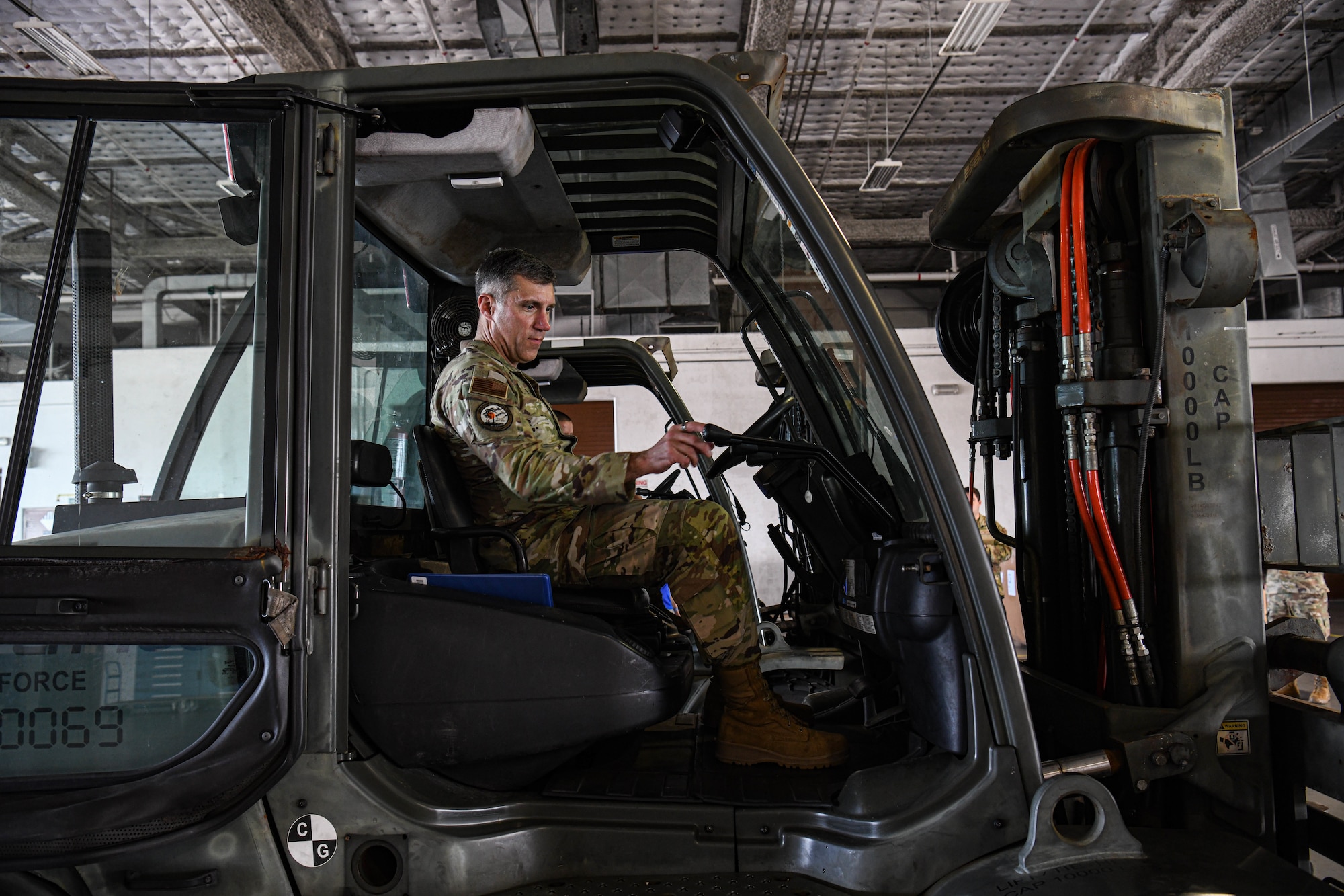 Maj. Gen. John Klein, U.S. Air Force Expeditionary Center commander, operates a forklift at Andersen Air Force Base, Guam, Dec. 2, 2023. Throughout the day, the USAFEC command team had the opportunity to experience aerial port and maintenance day-to-day tasks to get a better understanding of their mission.