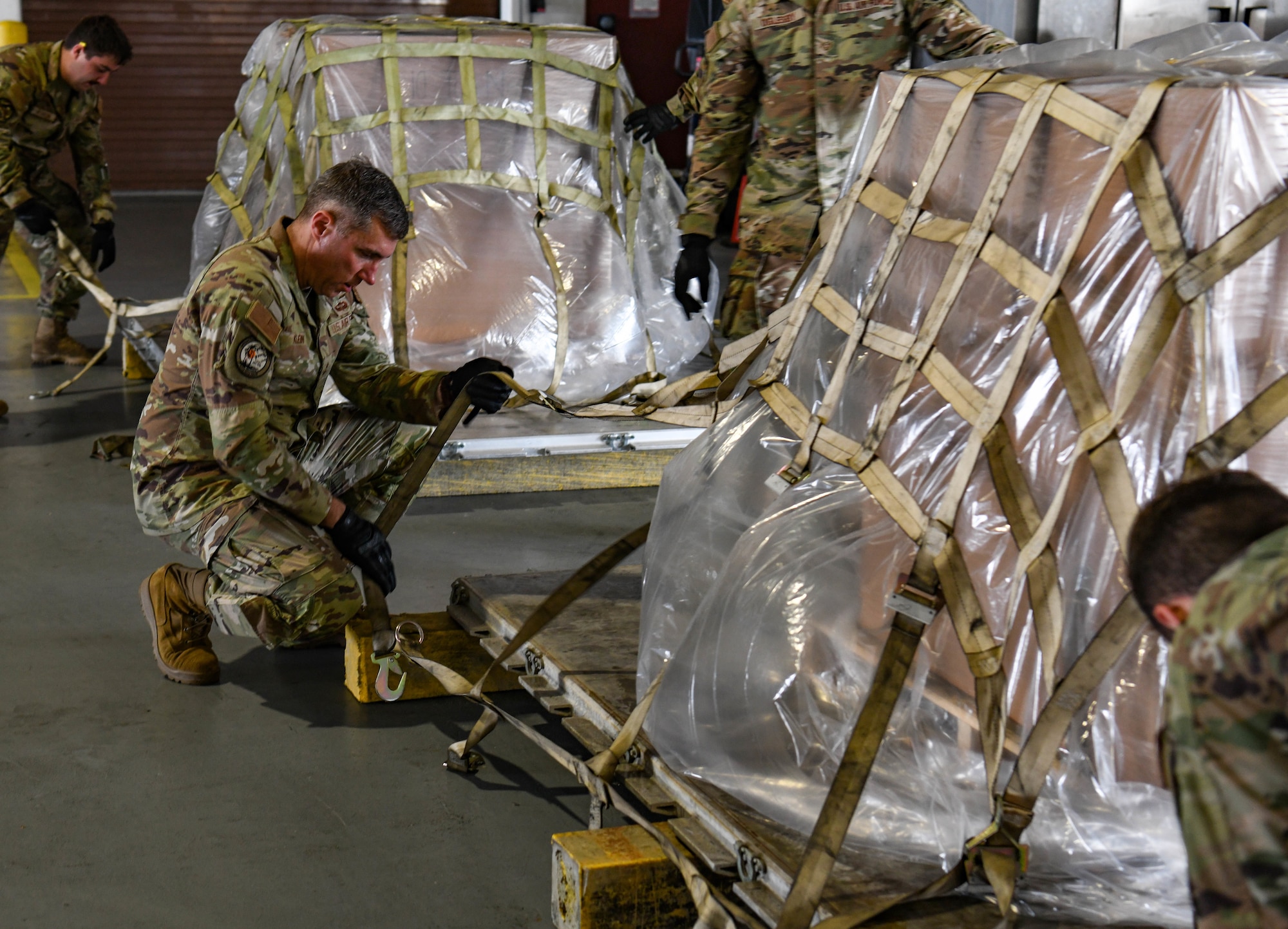 Maj. Gen. John Klein, U.S. Air Force Expeditionary Center commander, prepares a pallet at Andersen Air Force Base, Guam, Dec. 2, 2023. Throughout the day, the USAFEC command team had the opportunity to experience aerial port and maintenance day-to-day tasks to get a better understanding of their mission.
