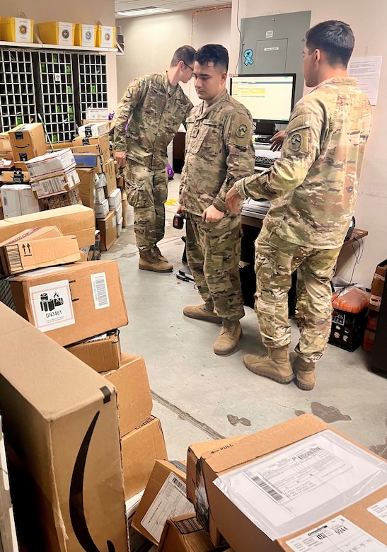 Soldiers of the 909th HR Co. (Postal) look over several Amazon packages and other mail just arriving into the Soto Cano Post Office mail room on Soto Cano Air Base near Comayagua, Honduras. The unit just kicked off a 9-month deployment providing postal operations at the air base.