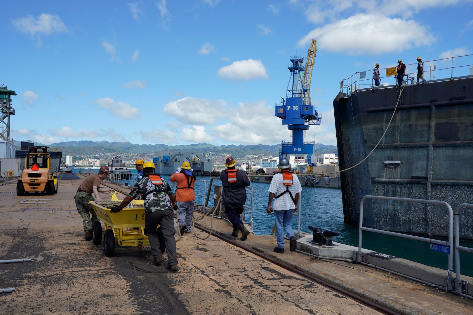 Pearl Harbor Naval Shipyard & Intermediate Maintenance Facility personnel assist in moving the caisson during the undocking of the Virginia-class attack submarine USS Minnesota (SSN 783) from Dry Dock 2, Oct. 12, 2023.