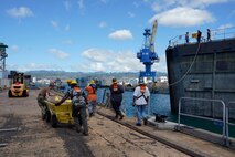Pearl Harbor Naval Shipyard & Intermediate Maintenance Facility personnel assist in moving the caisson during the undocking of the Virginia-class attack submarine USS Minnesota (SSN 783) from Dry Dock 2, Oct. 12, 2023.
