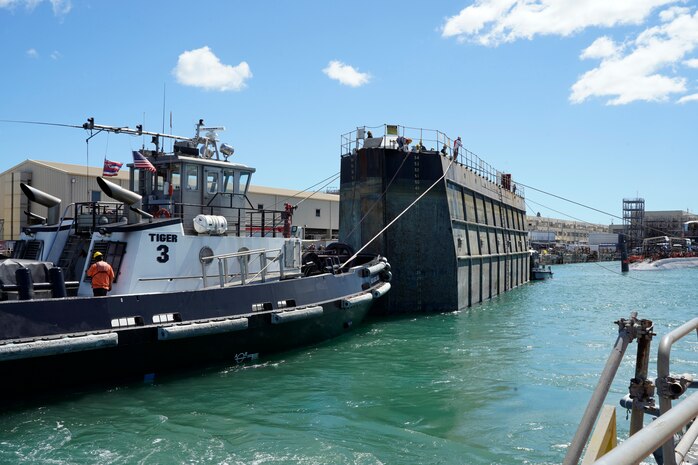 Tugboat ASD Daniel Akaka assists in moving the Dry Dock 2 caisson during the undocking of the Virginia-class attack submarine USS Minnesota (SSN 783) from Dry Dock 2, Oct. 12, 2023.