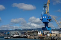 Tugboats direct the Dry Dock 2 caisson, center, pier-side during the undocking of the Virginia-class attack submarine USS Minnesota (SSN 783) from Dry Dock 2, Oct. 12, 2023.