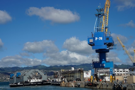 Tugboats direct the Dry Dock 2 caisson, center, pier-side during the undocking of the Virginia-class attack submarine USS Minnesota (SSN 783) from Dry Dock 2, Oct. 12, 2023.