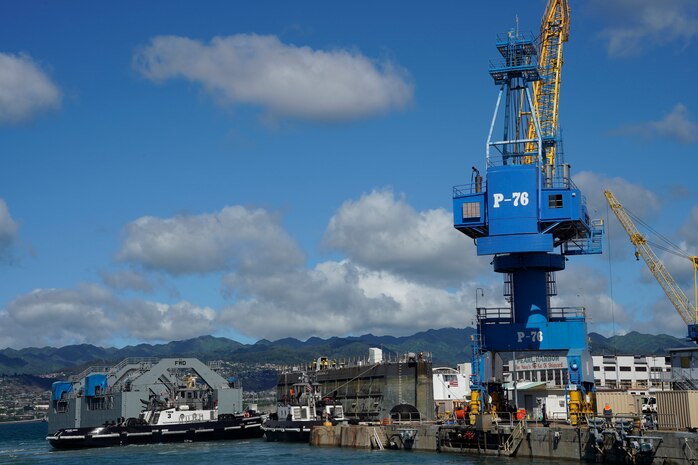 Tugboats direct the Dry Dock 2 caisson, center, pier-side during the undocking of the Virginia-class attack submarine USS Minnesota (SSN 783) from Dry Dock 2, Oct. 12, 2023.