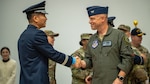 U.S. Air Force Col. Matthew C. Gaetke, right, 8th Fighter Wing commander, congratulates Republic of Korea Air Force Col. Byeong-Ki Ahn, 38th Fighter Group incoming commander, after the 38th FG change of command ceremony at Kunsan Air Base, Republic of Korea, Dec. 15, 2023. Ahn, also known as Eagle 37, assumed command of the 38th FG from outgoing commander Col. Choong-Won Oh. (U.S. Air Force photo by Senior Airman Karla Parra)