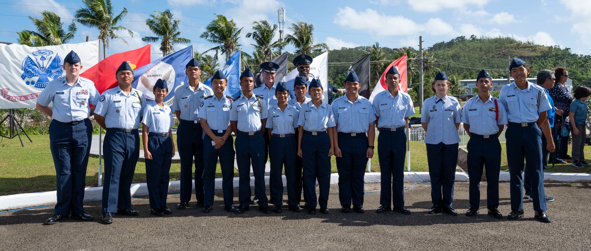 U.S. Air Force members and junior reserve officer training corps members pose for a photo after the Wreaths Across America ceremony at the Guam Veterans Cemetery, Guam, Dec. 16, 2023. The Wreaths Across America program allows families to honor and remember the sacrifices of our military Veterans by placing wreaths on their graves during the holiday season. (U.S. Air Force photo by Airman 1st Class Spencer Perkins)