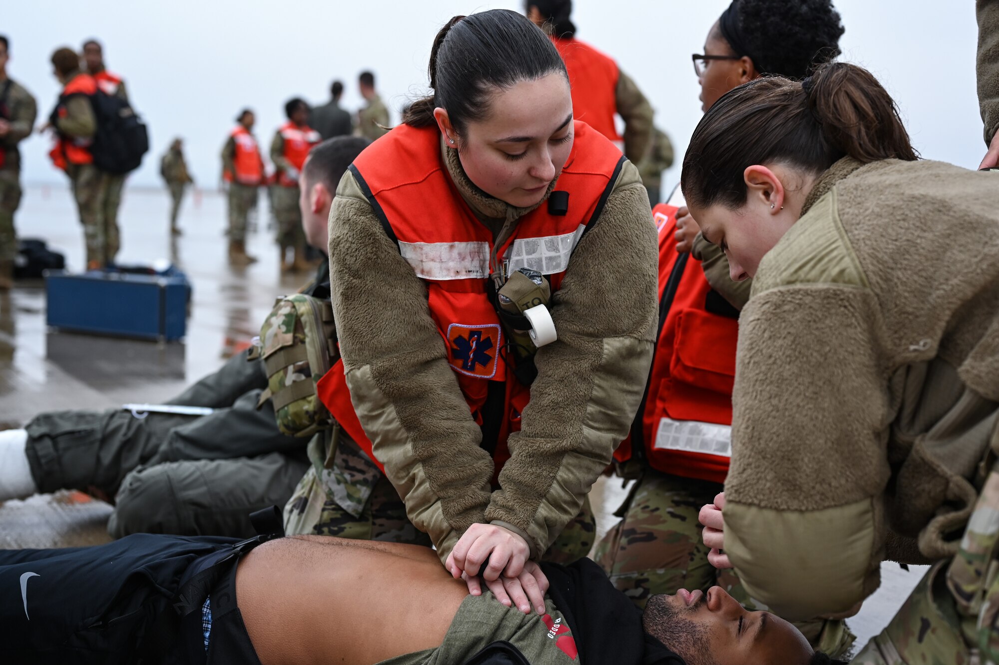 U.S. Air Force Senior Airman Madison Vega (left), 47th Medical Group family medicine technician and Airman 1st Class Morgann Trombley, 47th MDG dental technician, treat a simulated unresponsive patient during a Major Accident Response Exercise (MARE) on the flight line at Laughlin Air Force Base, Texas, Dec. 14, 2023.
