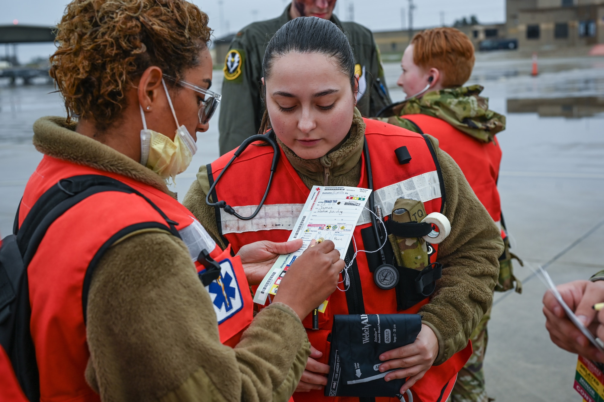 U.S. Air Force Airman 1st Class Ashley Beausoleil (left), 47th Medical Group health services management, and Senior Airman Madison Vega (right), 47th MDG family medicine technician fill out patient injury cards during a Major Accident Response Exercise (MARE) on the flight line at Laughlin Air Force Base, Texas, Dec. 14, 2023.